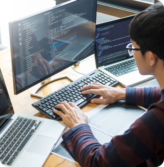 A man typing on a computer in visible one